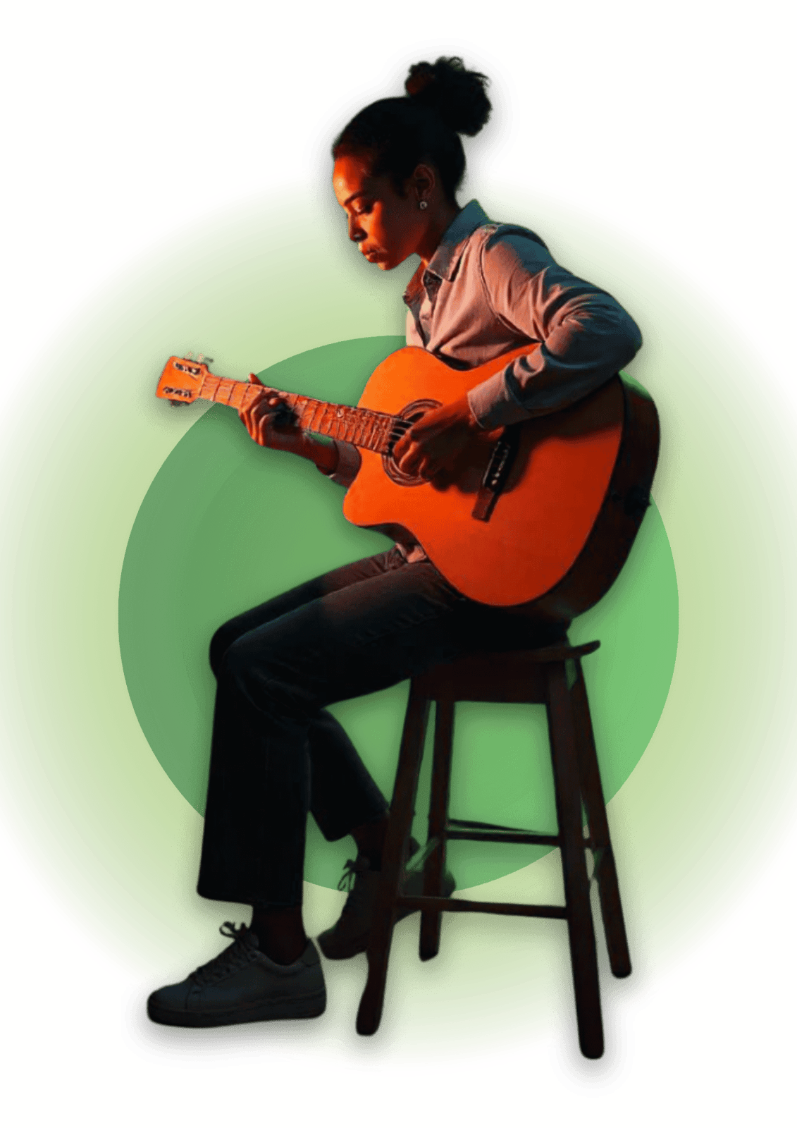 Young woman seated on a stool, focused on playing an acoustic guitar, showcasing dedication and love for music.